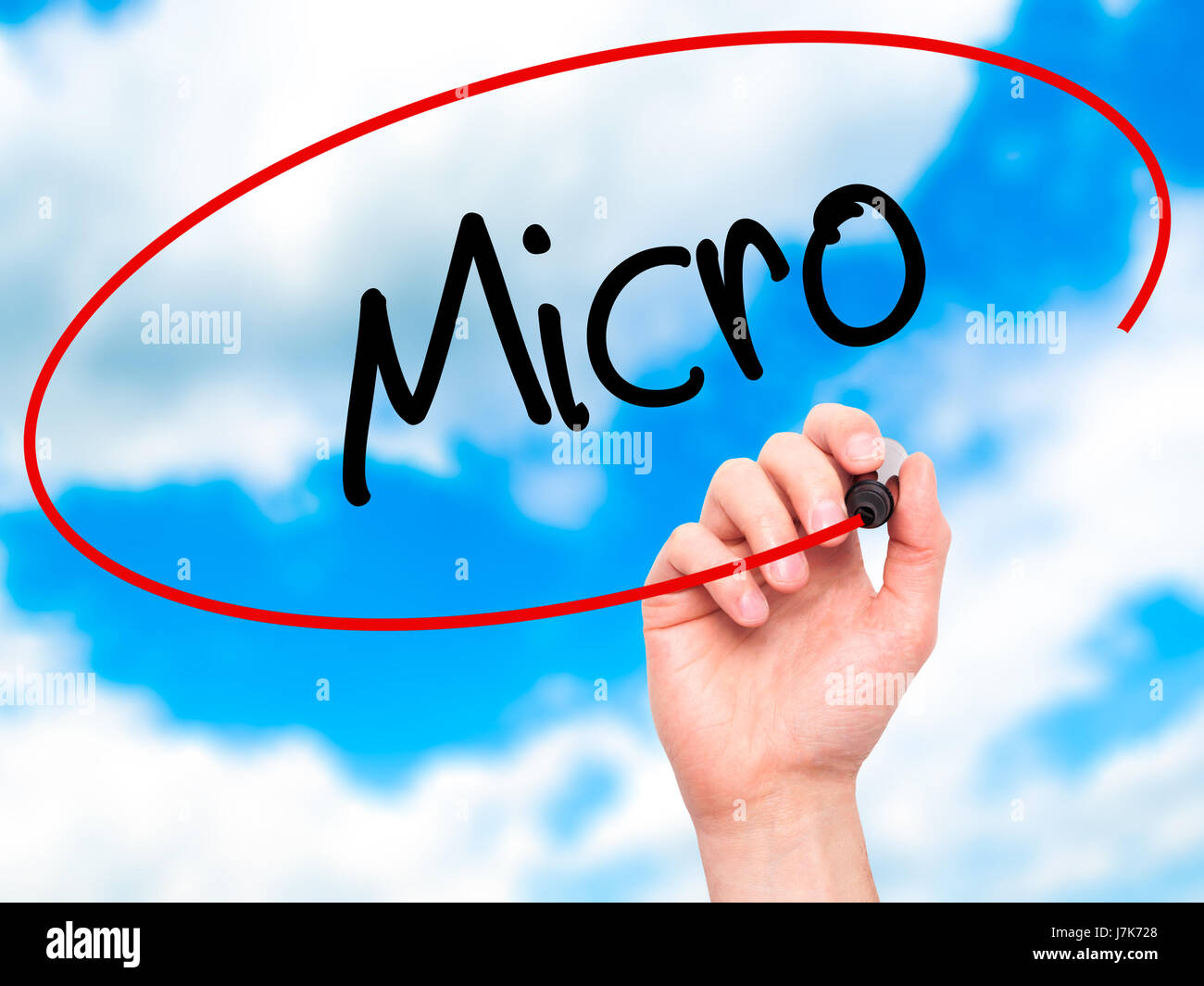 Man Hand writing Micro with black marker on visual screen. Isolated on background. Business, technology, internet concept. Stock Photo Stock Photo