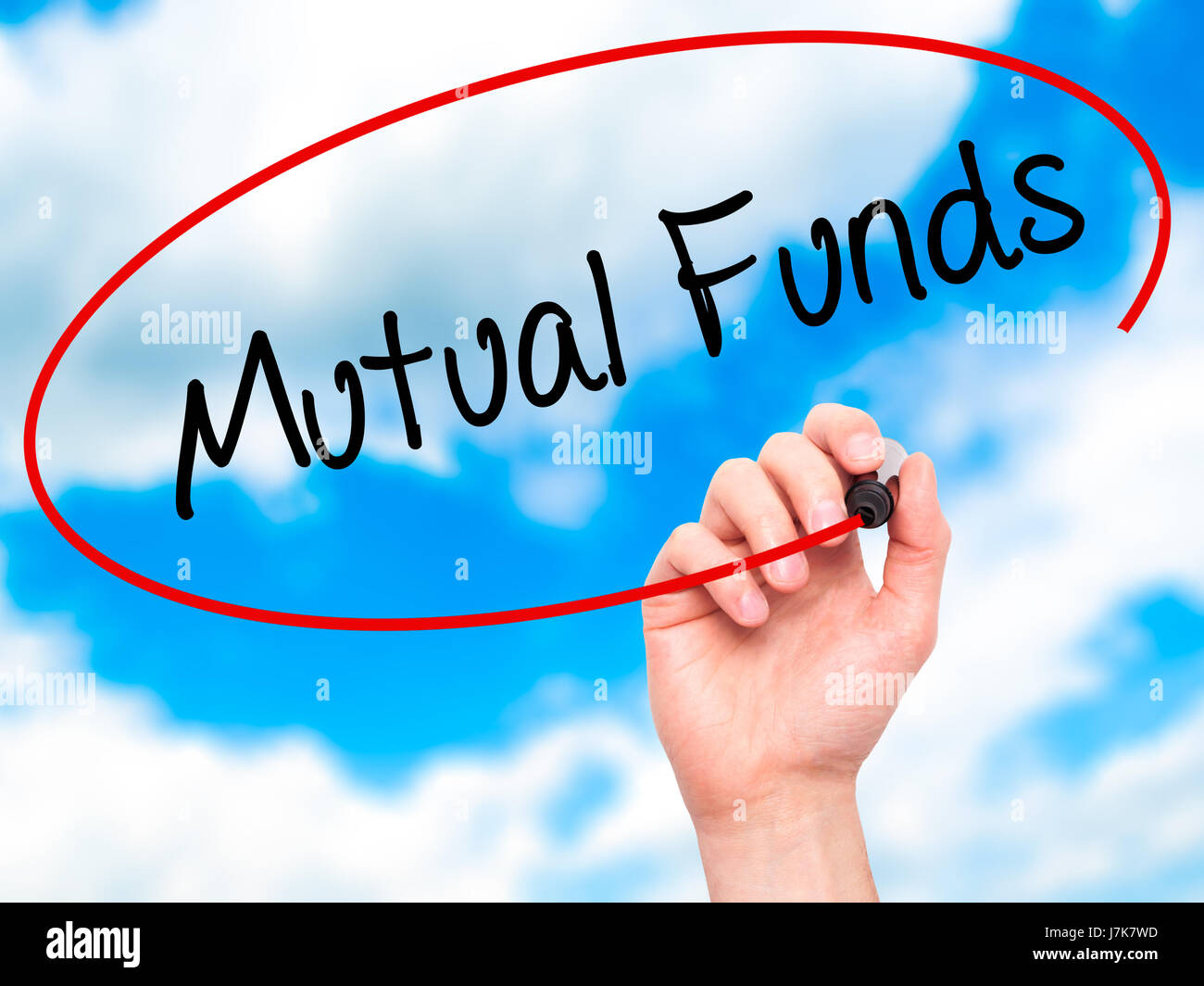 Man Hand writing Mutual Funds  with black marker on visual screen. Isolated on sky. Business, technology, internet concept. Stock Photo Stock Photo