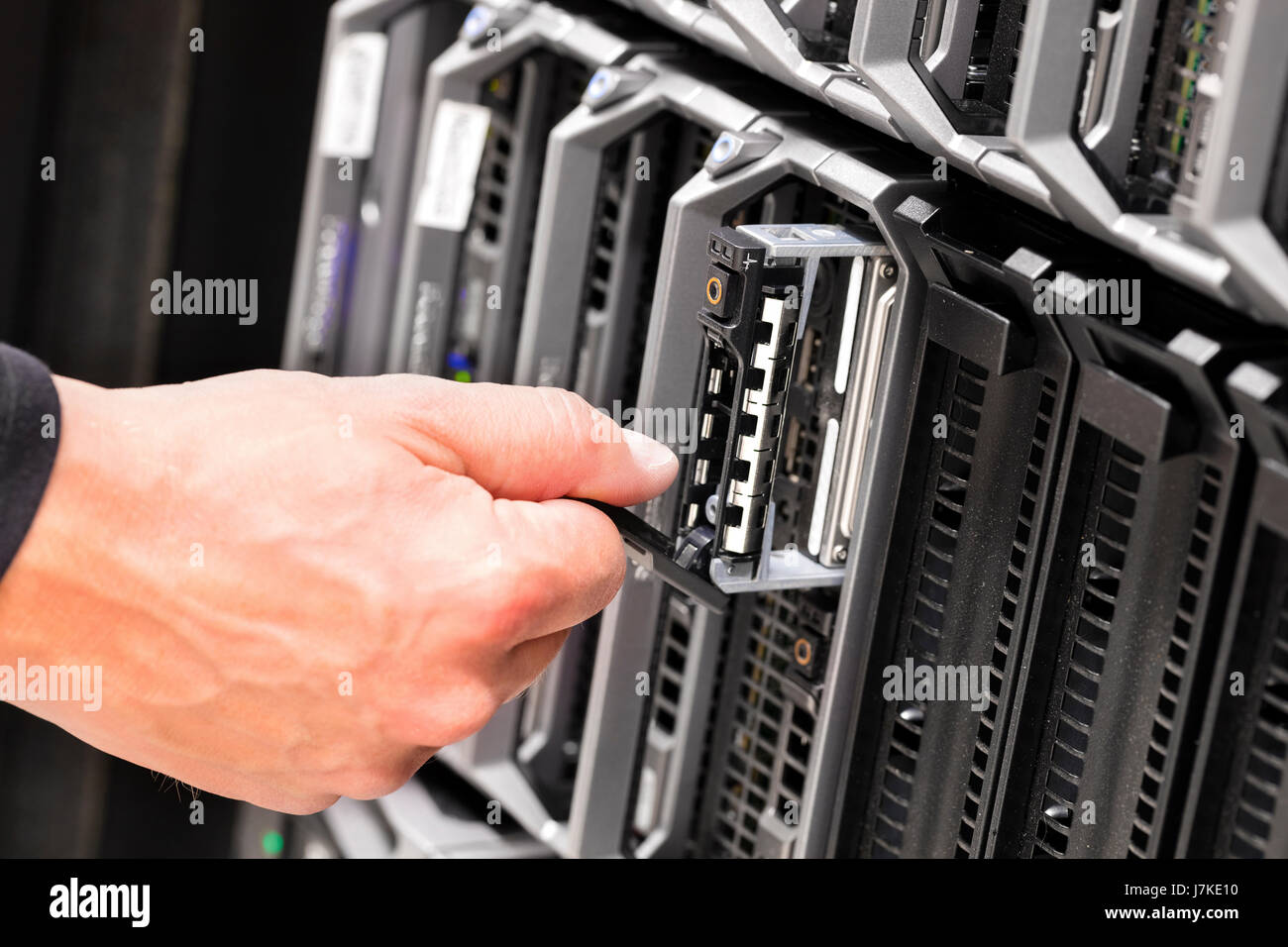 IT Technicians Repairing Harddrive on Server At Data Center Stock Photo