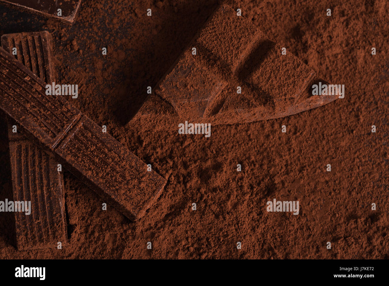 Top view of dark crashed chocolate bar covered in powder on a surface ...