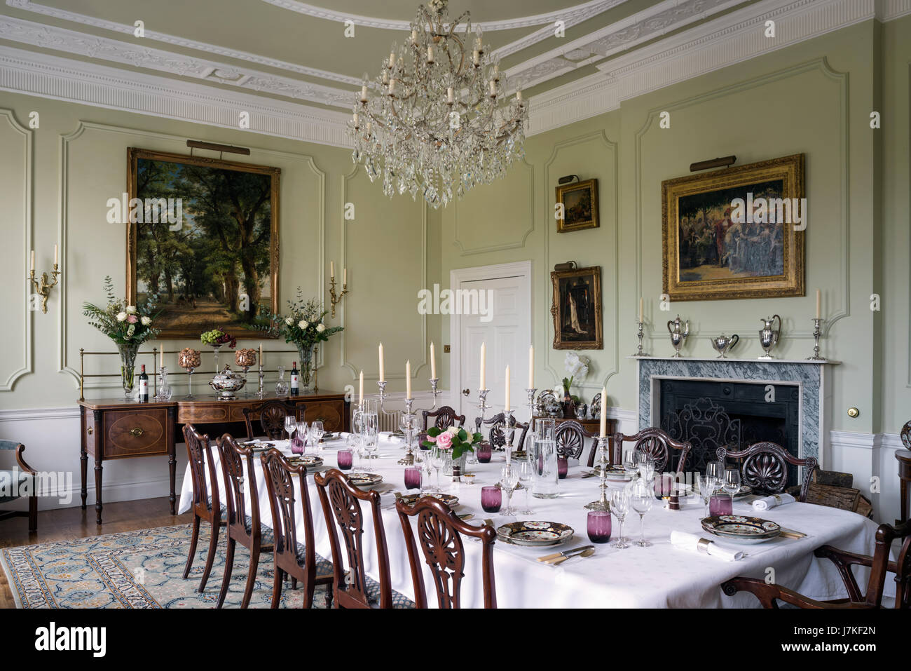 Georgian style dining chairs in grand dining room with glass chandelier and  antique sideboard Stock Photo - Alamy