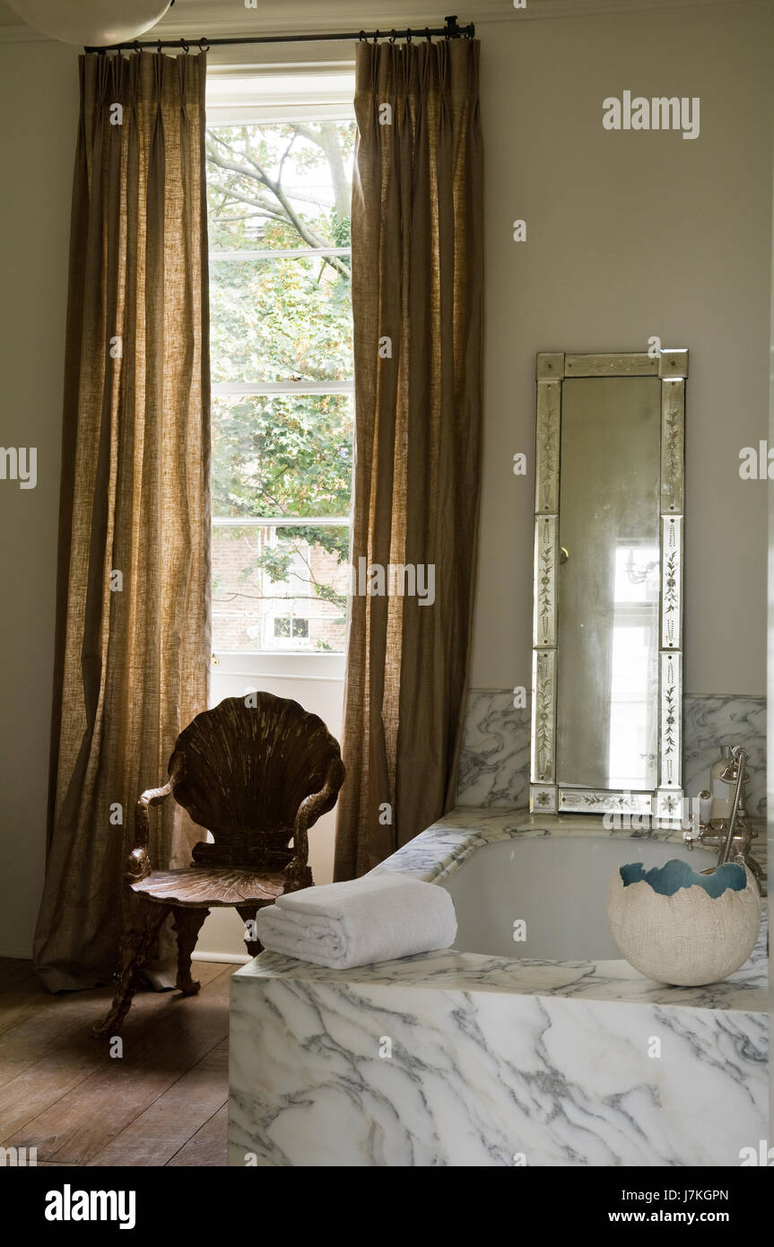 Shell chair in window of Portland Place bathroom with marble surround, Portland Road, London, UK Stock Photo
