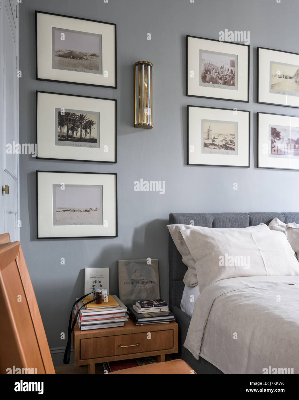 18th century black and white prints with 1940s Murano glass wall light in calm grey tone bedroom Stock Photo