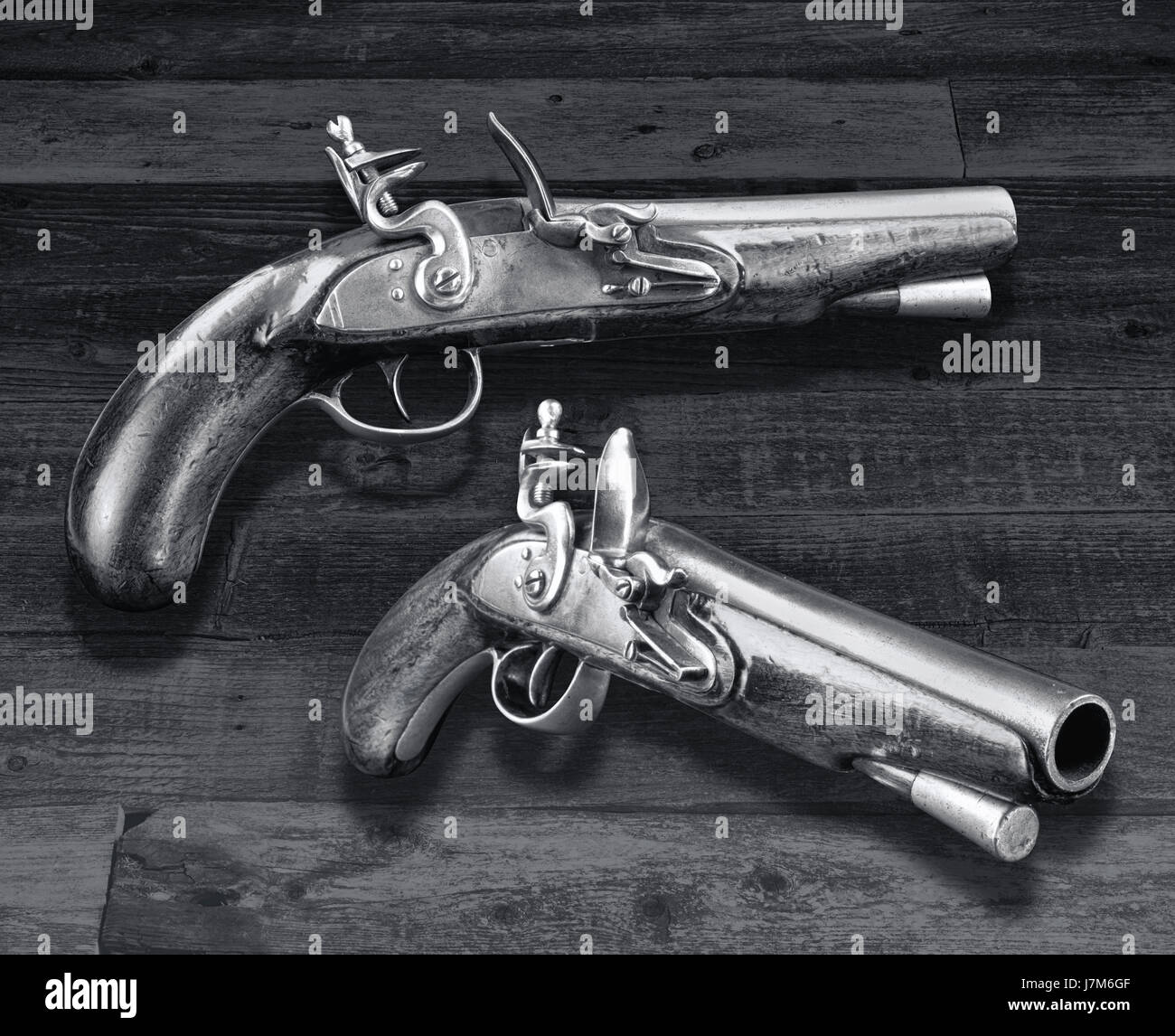 Antique English flintlock pistols made in the late 1700's in black and white. Stock Photo