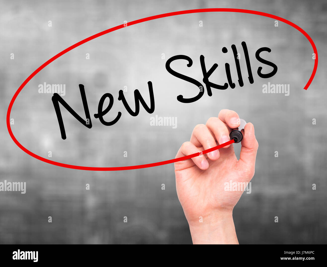 Man Hand writing New Skills with black marker on visual screen ...