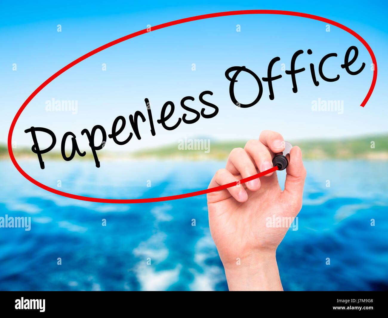 Man Hand writing Paperless Office with black marker on visual screen ...