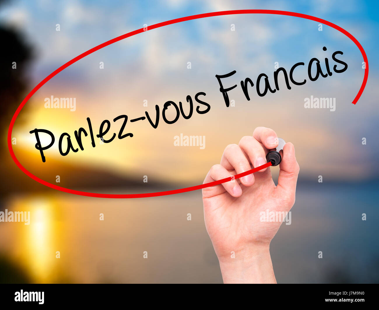Man Hand writing Parlezvous franĂ ?Ă‚Â§ais?(Do You Speak French? in French) with black marker