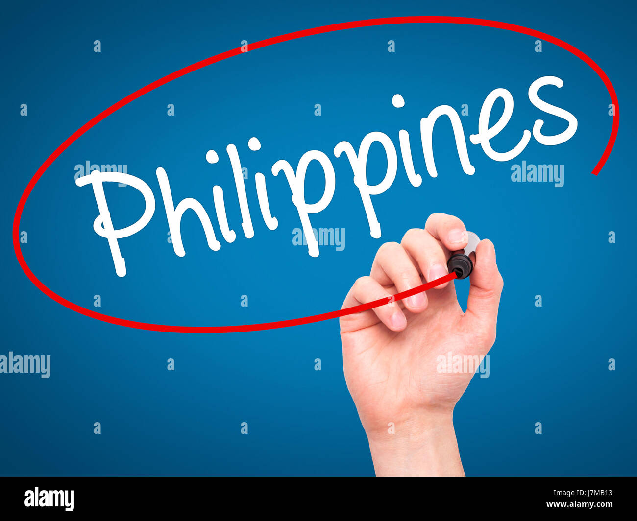 Man Hand writing Philippines with black marker on visual screen. Isolated on blue. Business, technology, internet concept. Stock Photo Stock Photo