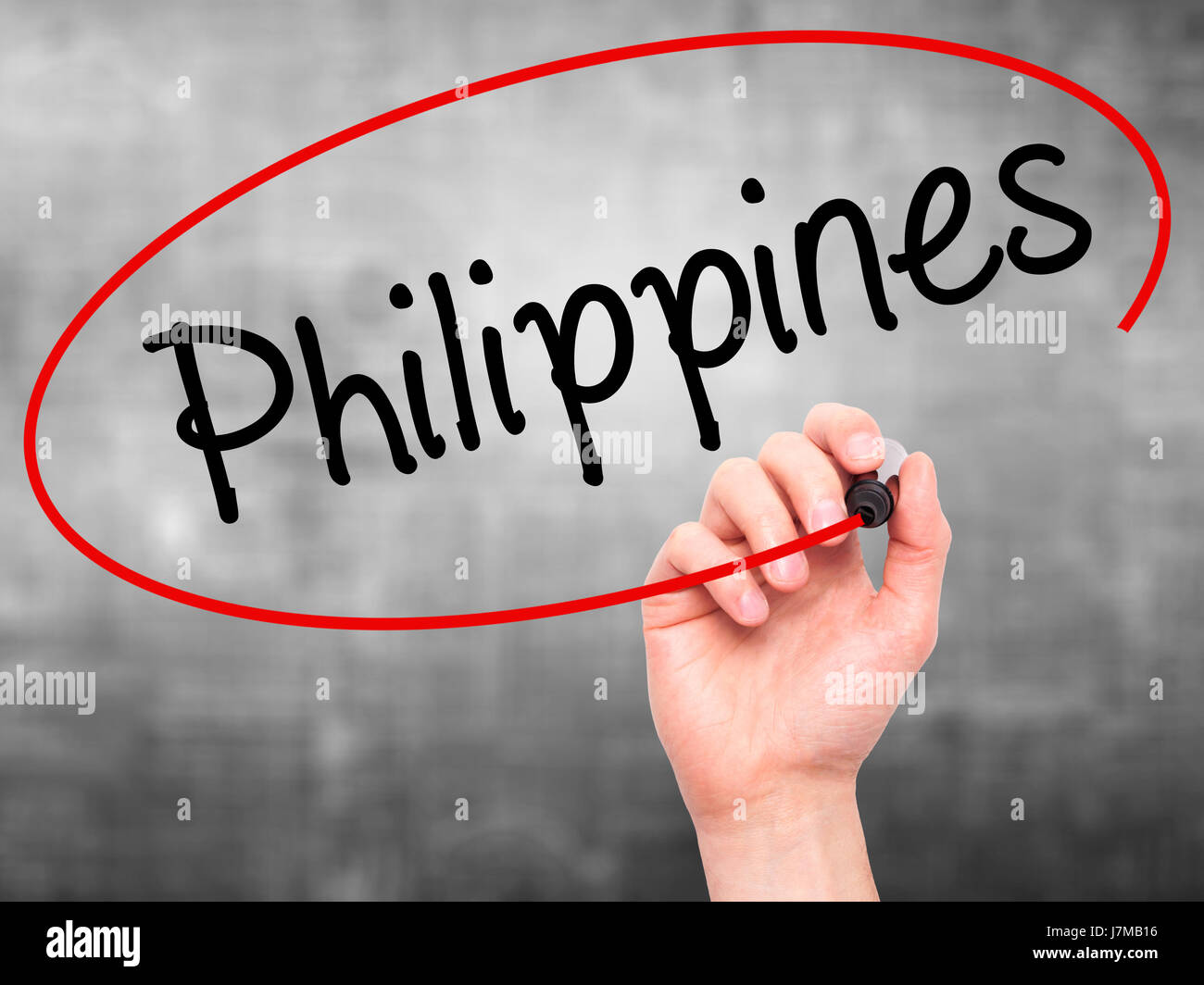 Man Hand writing Philippines with black marker on visual screen. Isolated on grey. Business, technology, internet concept. Stock Photo Stock Photo
