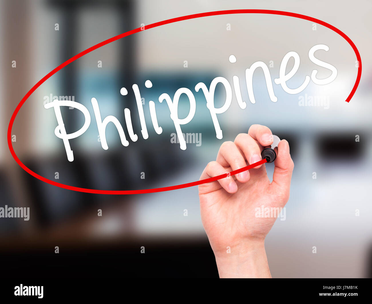 Man Hand writing Philippines with black marker on visual screen. Isolated on office. Business, technology, internet concept. Stock Photo Stock Photo