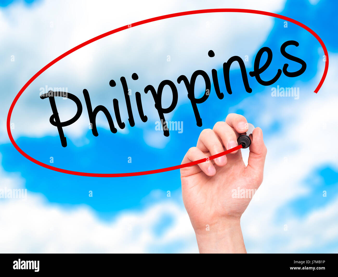 Man Hand writing Philippines with black marker on visual screen. Isolated on sky. Business, technology, internet concept. Stock Photo Stock Photo