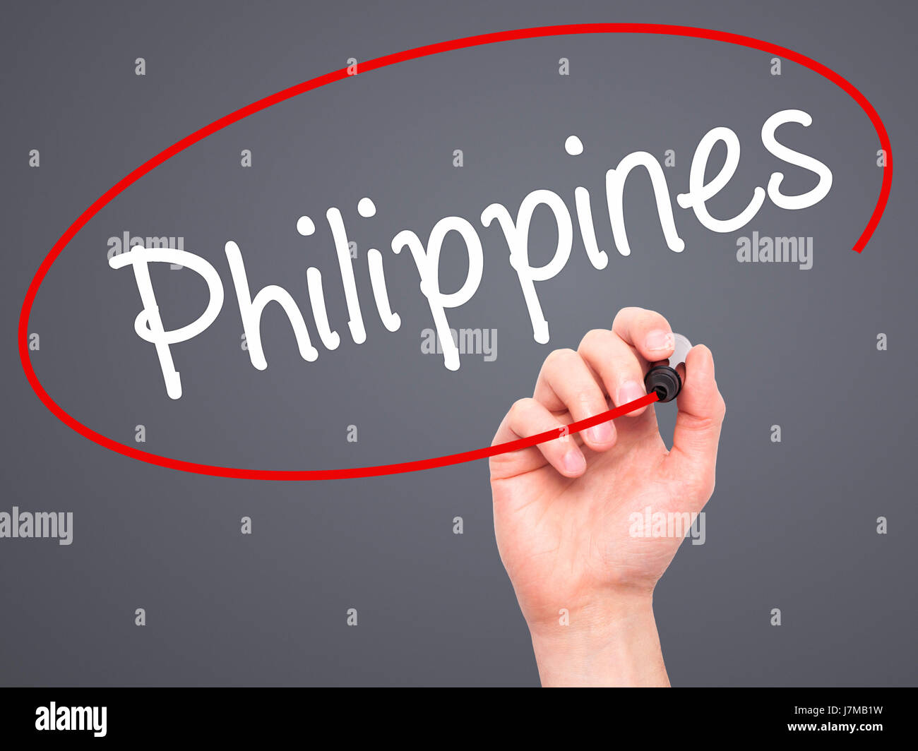 Man Hand writing Philippines with black marker on visual screen. Isolated on grey. Business, technology, internet concept. Stock Photo Stock Photo