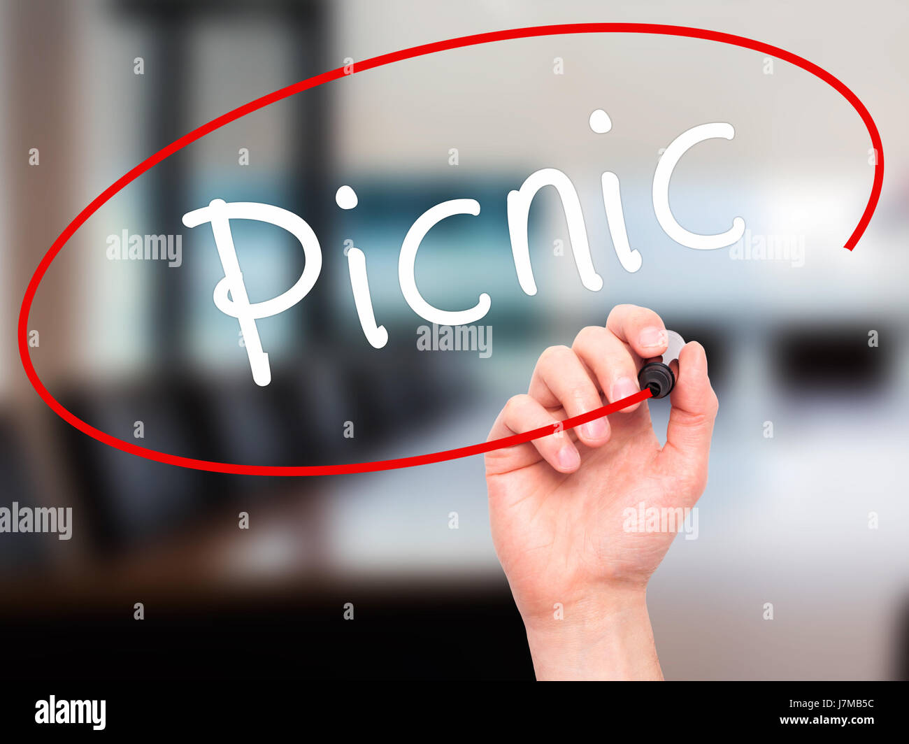 Man Hand writing Picnic with black marker on visual screen. Isolated on office. Business, technology, internet concept. Stock Photo Stock Photo