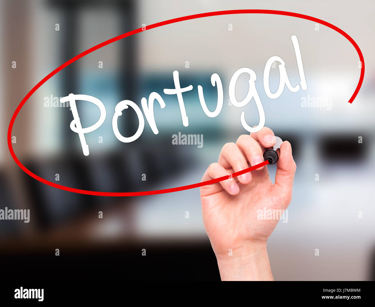 Man Hand writing  Portugal  with black marker on visual screen. Isolated on office. Business, technology, internet concept. Stock Photo Stock Photo