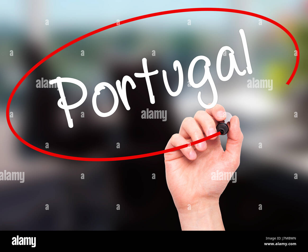 Man Hand writing  Portugal  with black marker on visual screen. Isolated on office. Business, technology, internet concept. Stock Photo Stock Photo