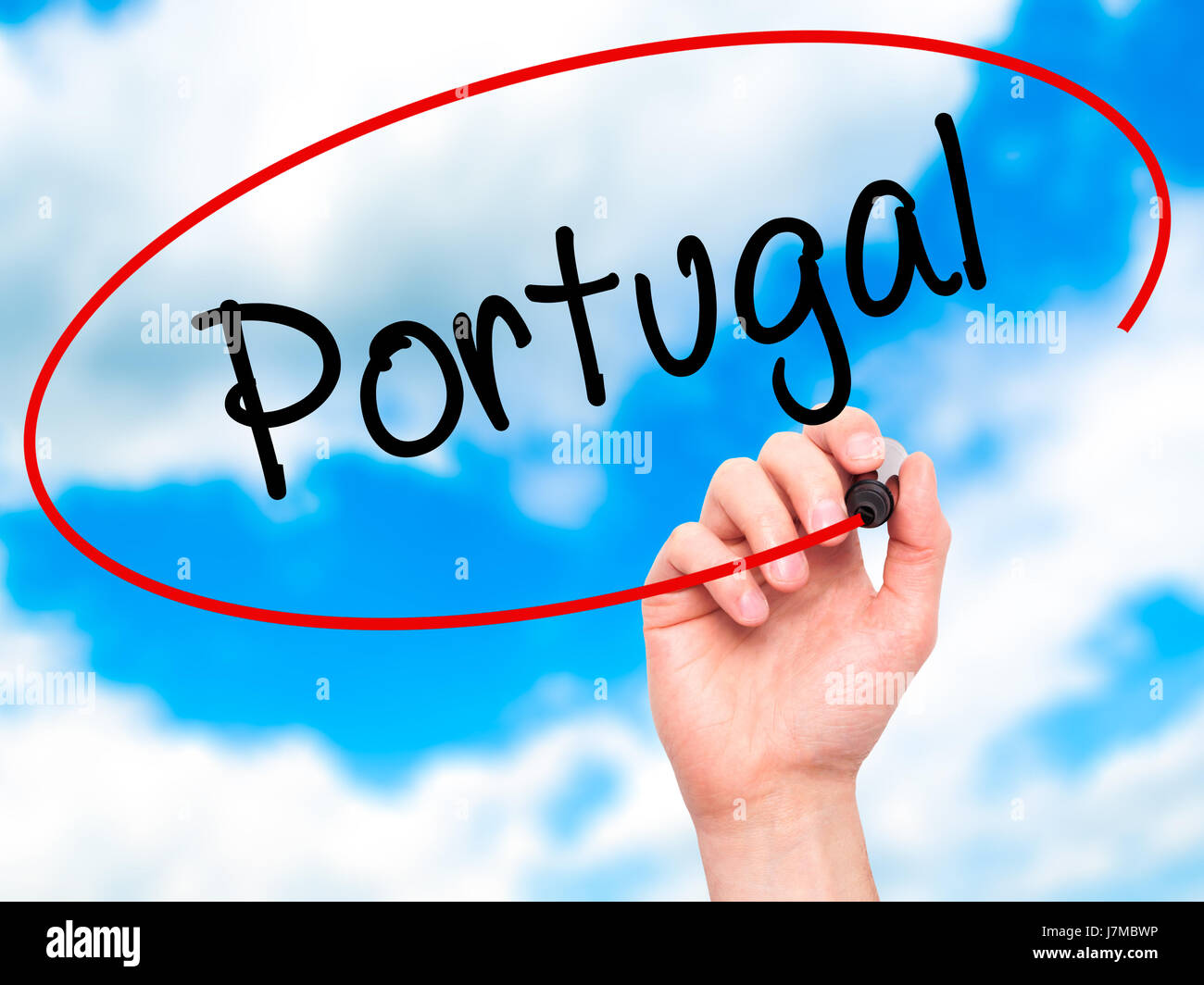 Man Hand writing  Portugal  with black marker on visual screen. Isolated on sky. Business, technology, internet concept. Stock Photo Stock Photo