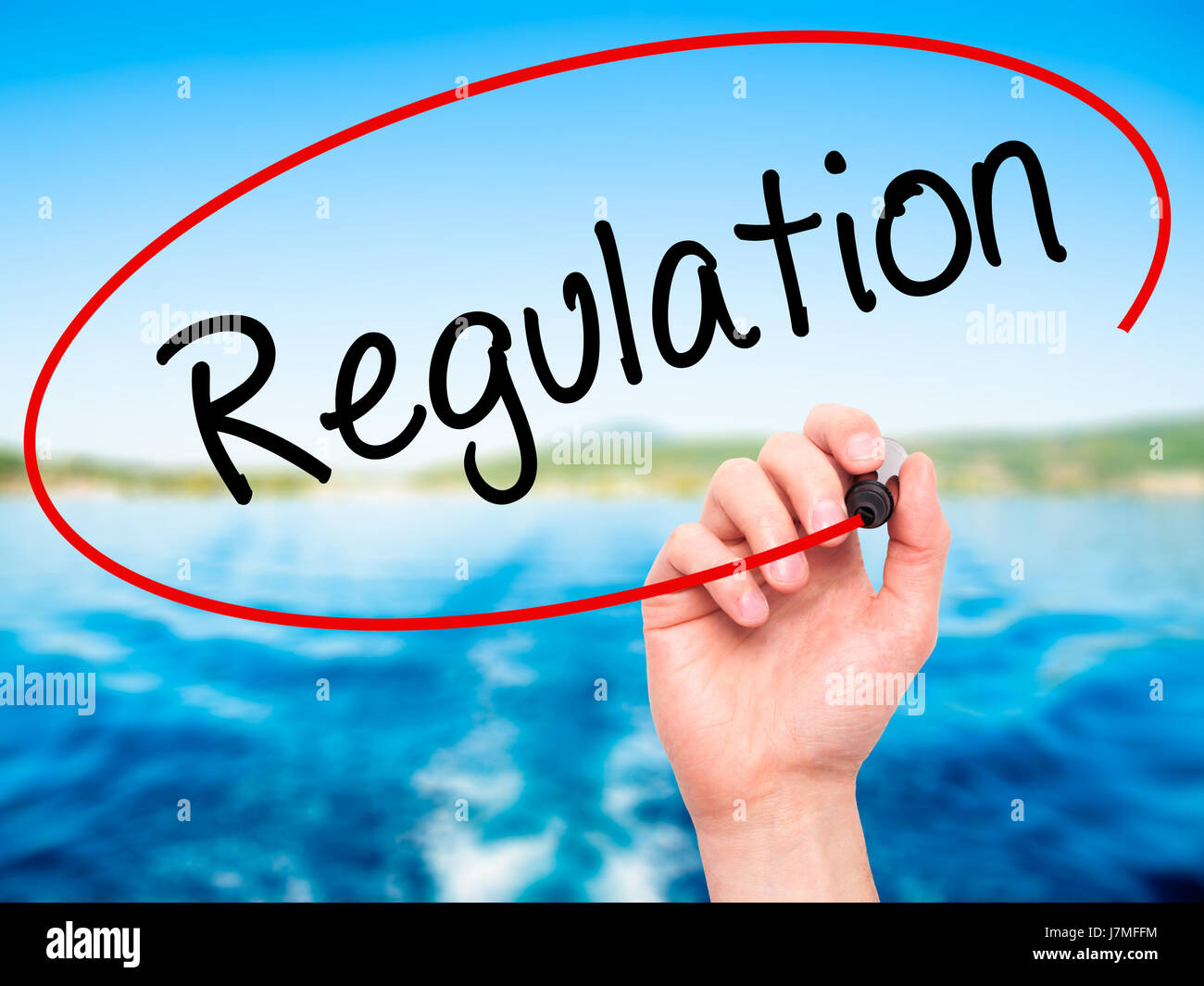 Man Hand writing Regulation with black marker on visual screen ...