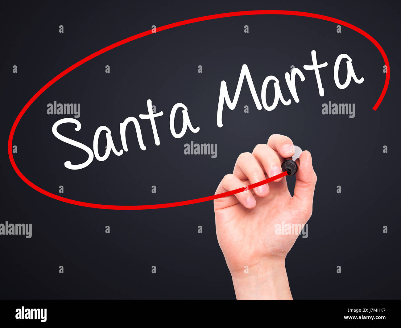 Man Hand writing Santa Marta with black marker on visual screen. Isolated on black. Business, technology, internet concept. Stock Photo