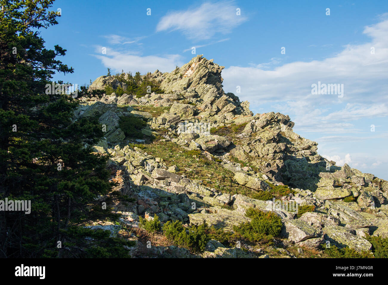 top of the rock under the blue sky with clouds Stock Photo - Alamy