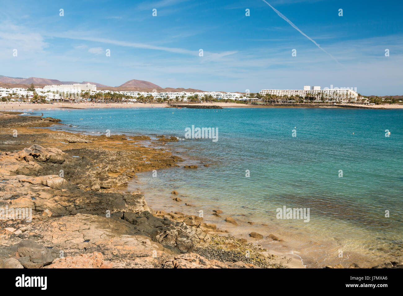 Costa Teguise Beach in Lanzarote, Spain with the village in the background. Stock Photo