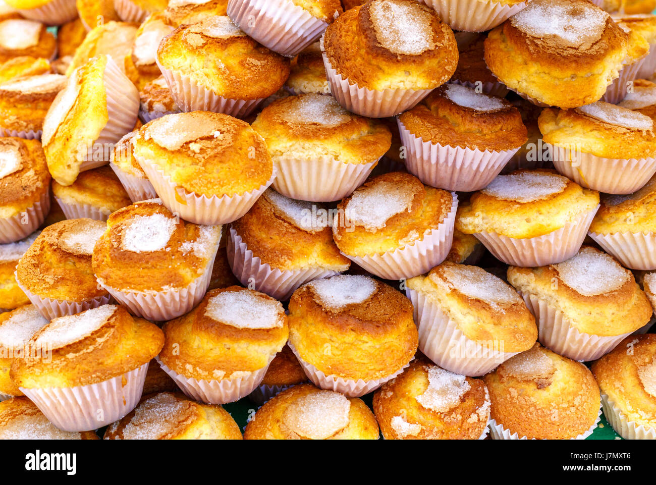 Pile of delicious baked muffins background Stock Photo Alamy