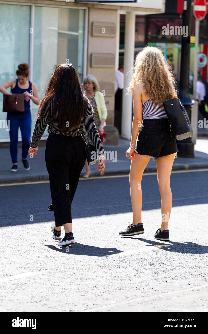 Dundee, UK. 25th May, 2017. UK Weather: A dry day with very warm sunshine as hot weather set to continue across Tayside with Maximum temperature of 25 °C. The heatwave with basking temperatures are set to continue in Tayside over the next few days. Two women together walking across the road in the city centre enjoying the glorious warm weather. Credit: Dundee Photographics /Alamy Live News Stock Photo