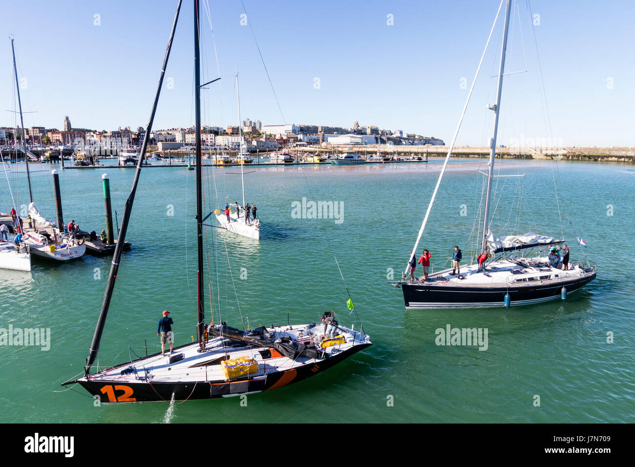 England, Ramsgate. Yachts sailing into harbour after competing in the
