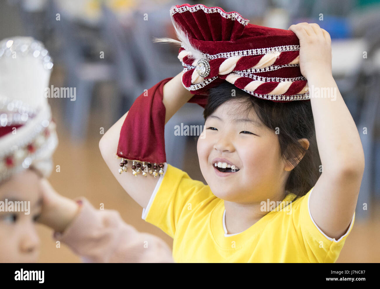 World costume fest A child tries on a foreign outfit at a costume