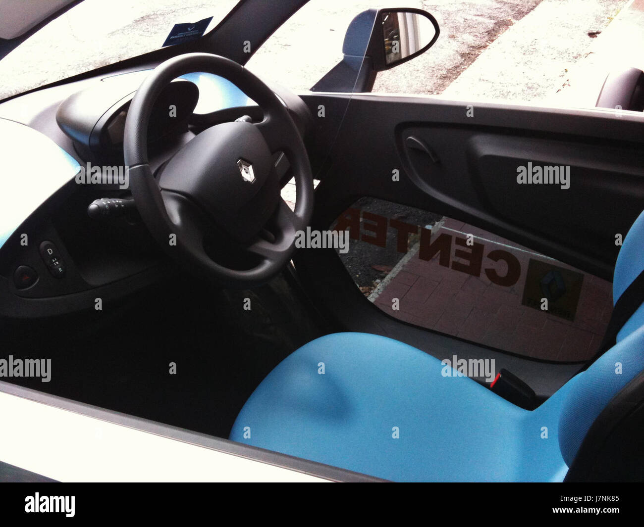 The interior view of the 2012 Renault Twizy, a small electric vehicle designed for urban commuting, showcasing its compact, functional design. Stock Photo