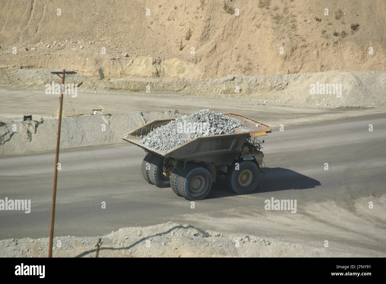 This photograph depicts a truck at Bingham Canyon Mine in Utah, taken on September 29, 2012. Bingham Canyon is one of the largest open-pit copper mines in the world, and this image captures the scale of mining operations and heavy machinery used in extracting valuable minerals. Stock Photo