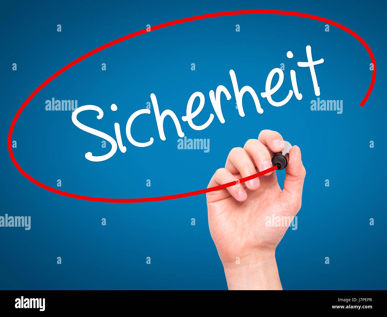 Man Hand writing Sicherheit (Safety in German) with black marker on
