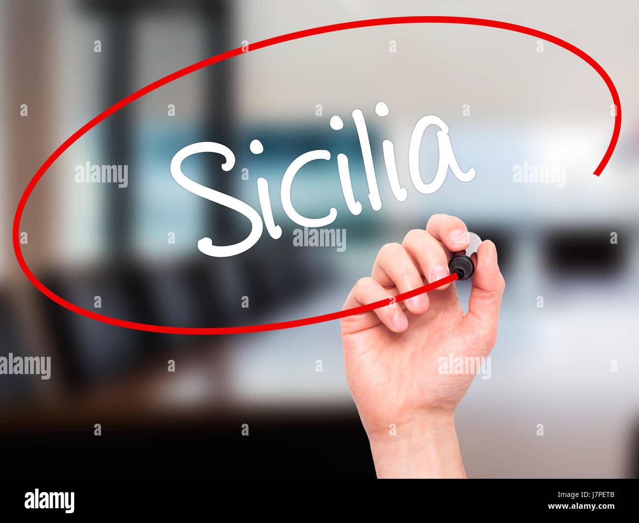 Man Hand writing Sicilia (Sicily In Italian)  with black marker on visual screen. Isolated on office. Business, technology, internet concept. Stock Ph Stock Photo