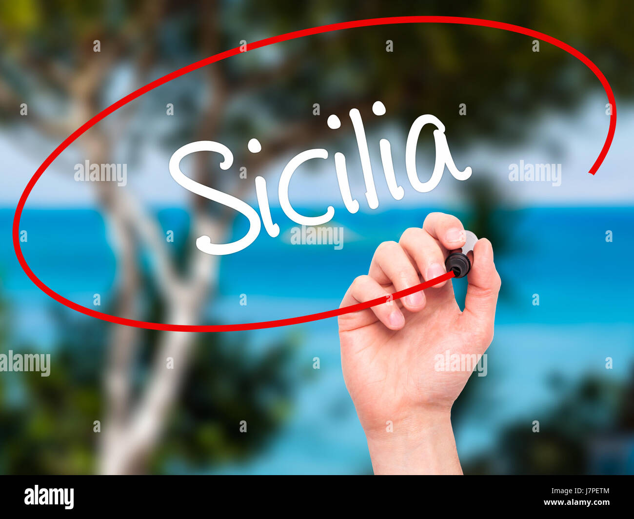 Man Hand writing Sicilia (Sicily In Italian)  with black marker on visual screen. Isolated on nature. Business, technology, internet concept. Stock Ph Stock Photo