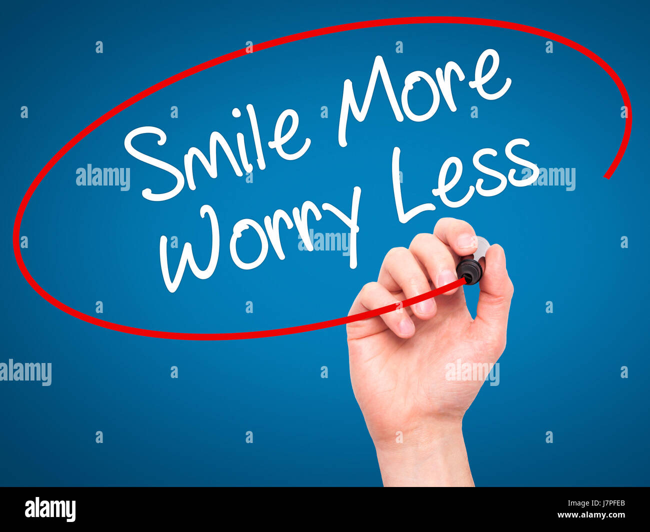 Less Worry Face Man Hand writing Smile More Worry Less with black marker on visual ...