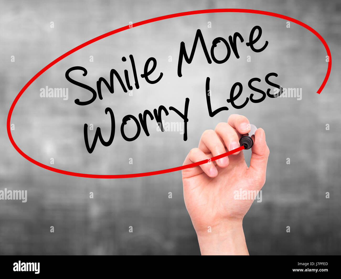 Less Worry Face Man Hand writing Smile More Worry Less with black marker on visual ...