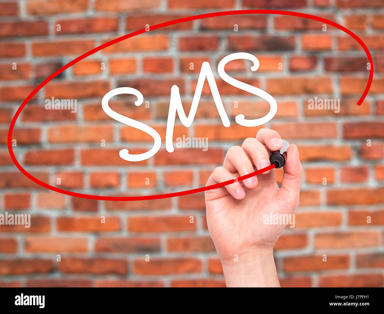 Man Hand writing SMS (Short Message Service) with black marker on