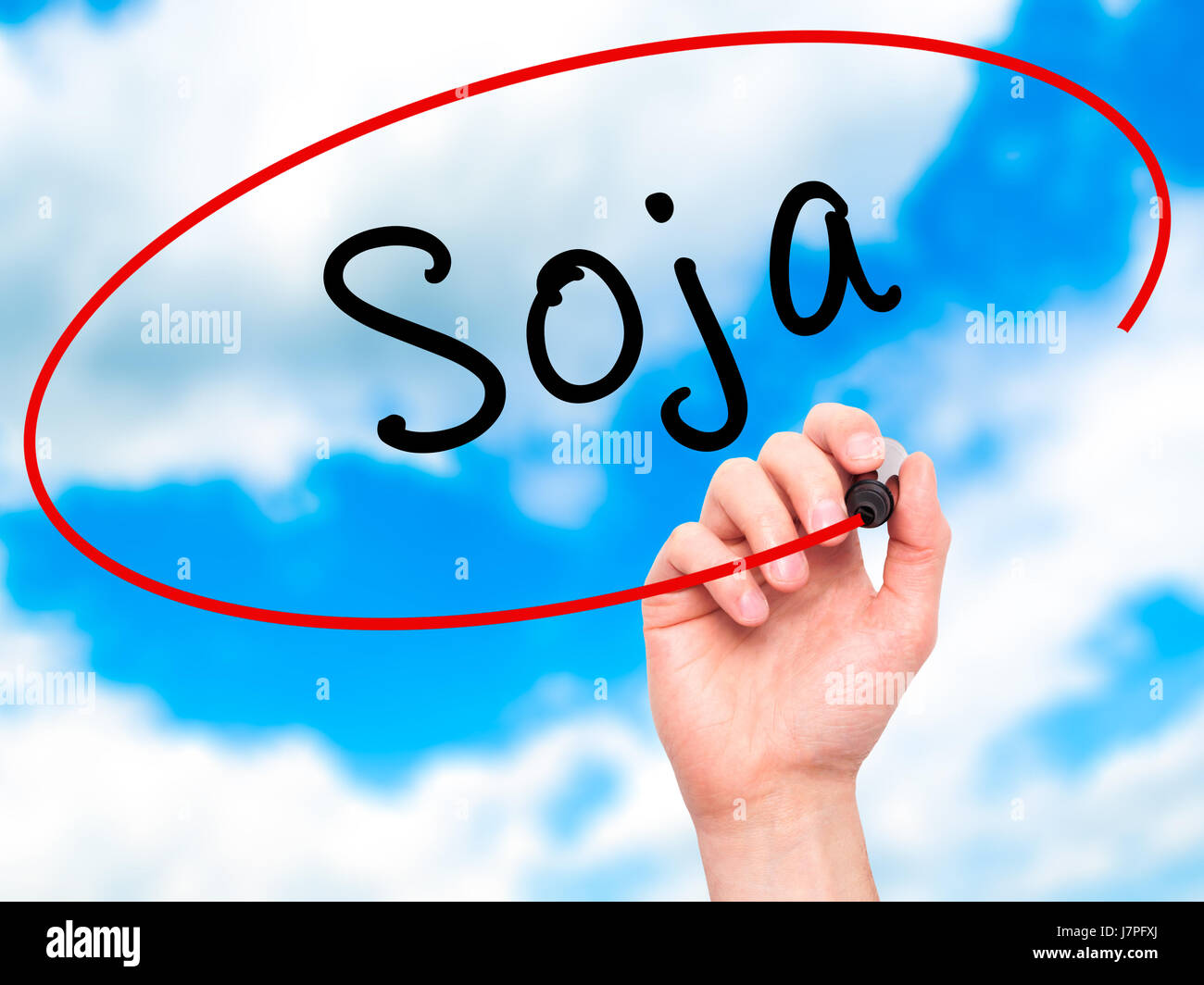 Man Hand writing Soja (Soybean in Portuguese) with black marker on