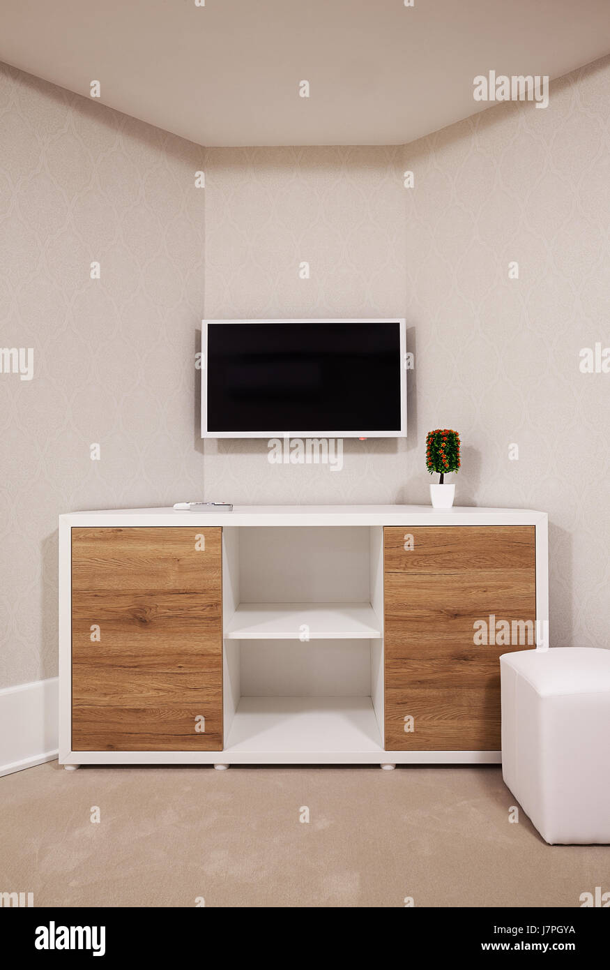 One modern LCD on wall with wooden closet in front, one corner of a room  Stock Photo - Alamy