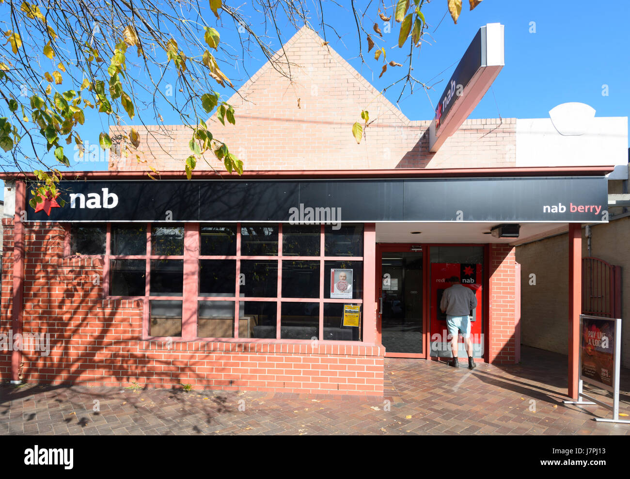 Customer withdrawing cash at the ATM of a Local NAB Branch, Berry, New South Wales, NSW, Australia Stock Photo