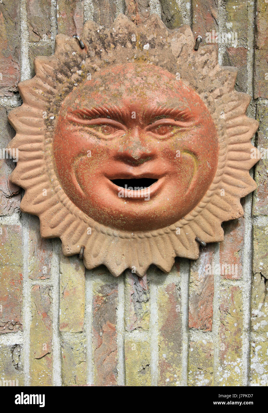 Smiling Terracotta Sun Face Stock Photo