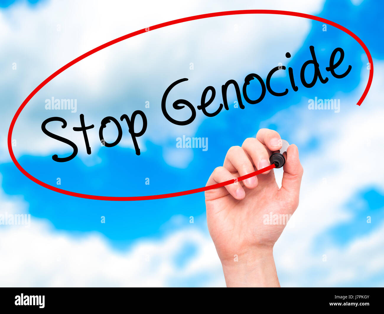 Man Hand writing Stop Genocide with black marker on visual screen. Isolated on background. Business, technology, internet concept. Stock Photo Stock Photo