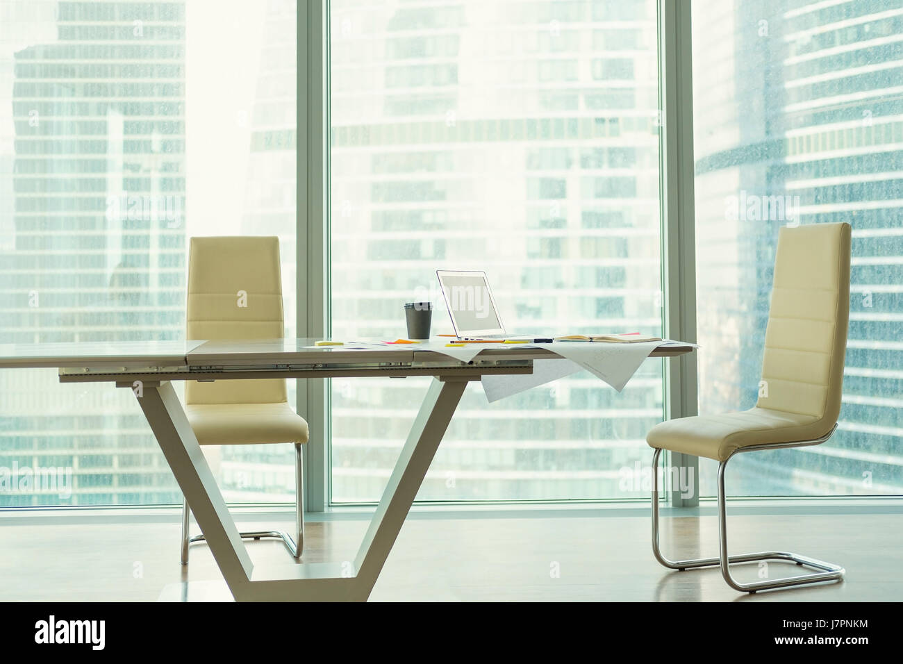 Corporate office interior with modern table, two chairs Stock Photo - Alamy
