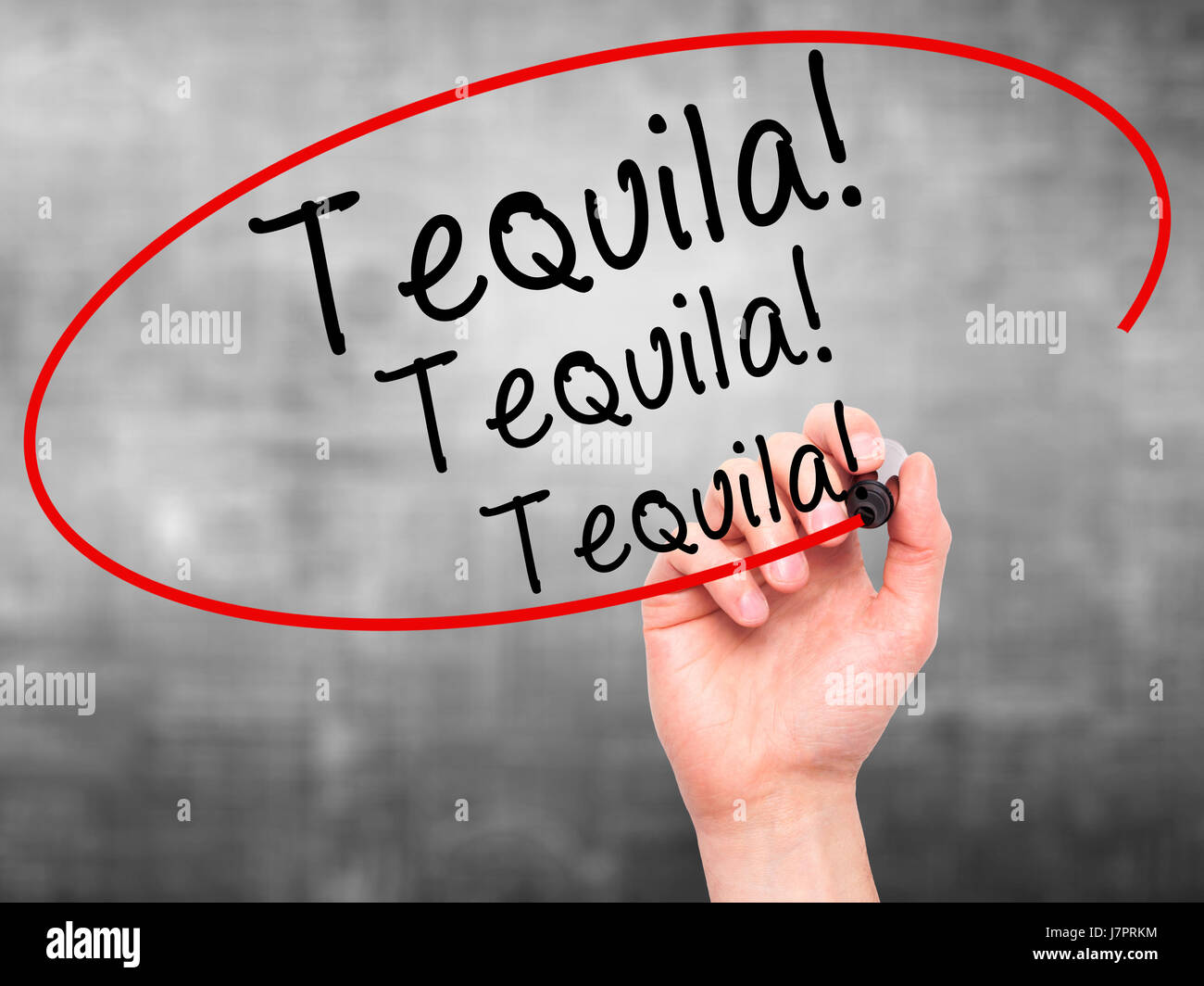 Man Hand writing Tequila with black marker on visual screen. Isolated on grey. Business, technology, internet concept. Stock Photo Stock Photo