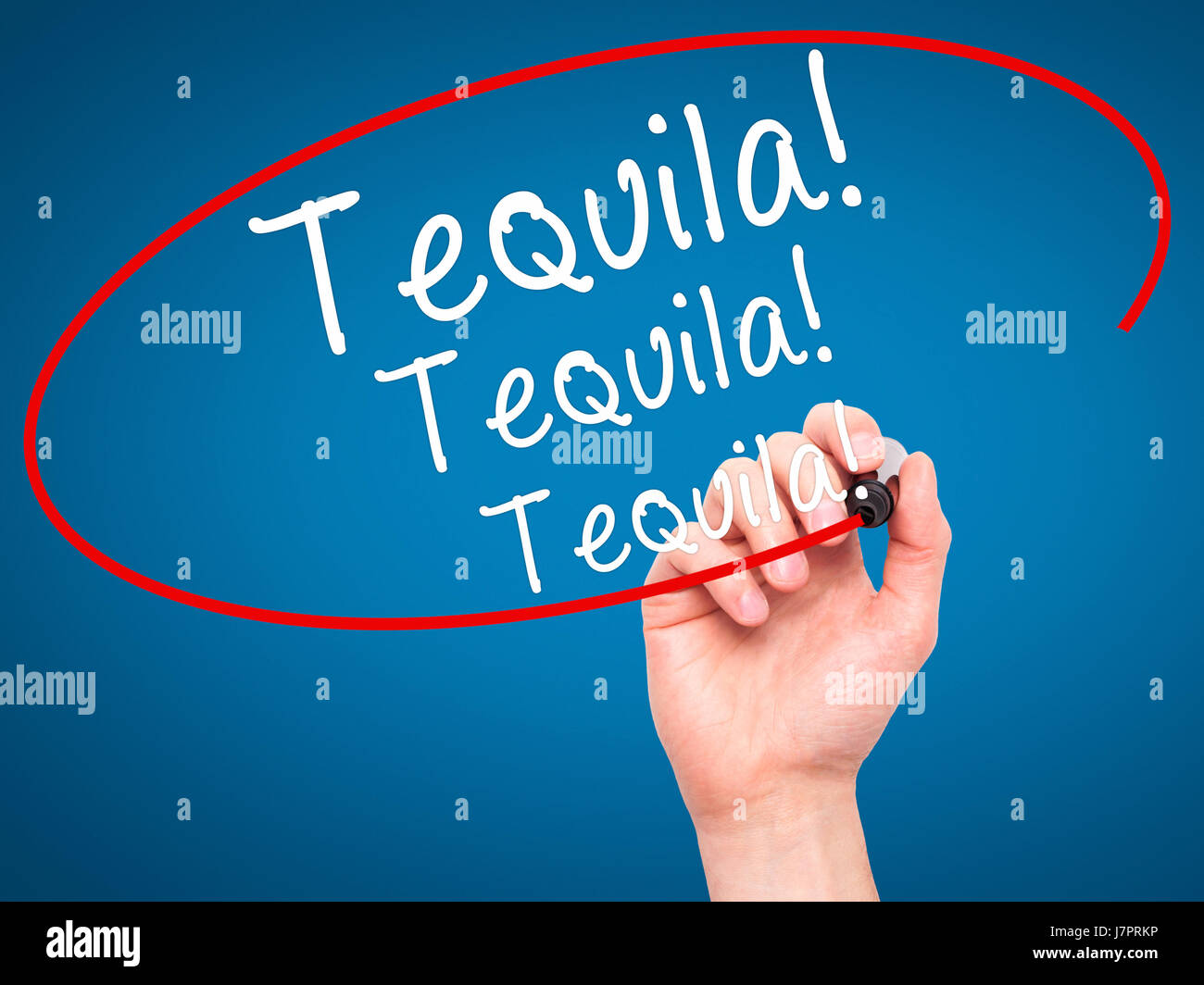 Man Hand writing Tequila with black marker on visual screen. Isolated on blue. Business, technology, internet concept. Stock Photo Stock Photo