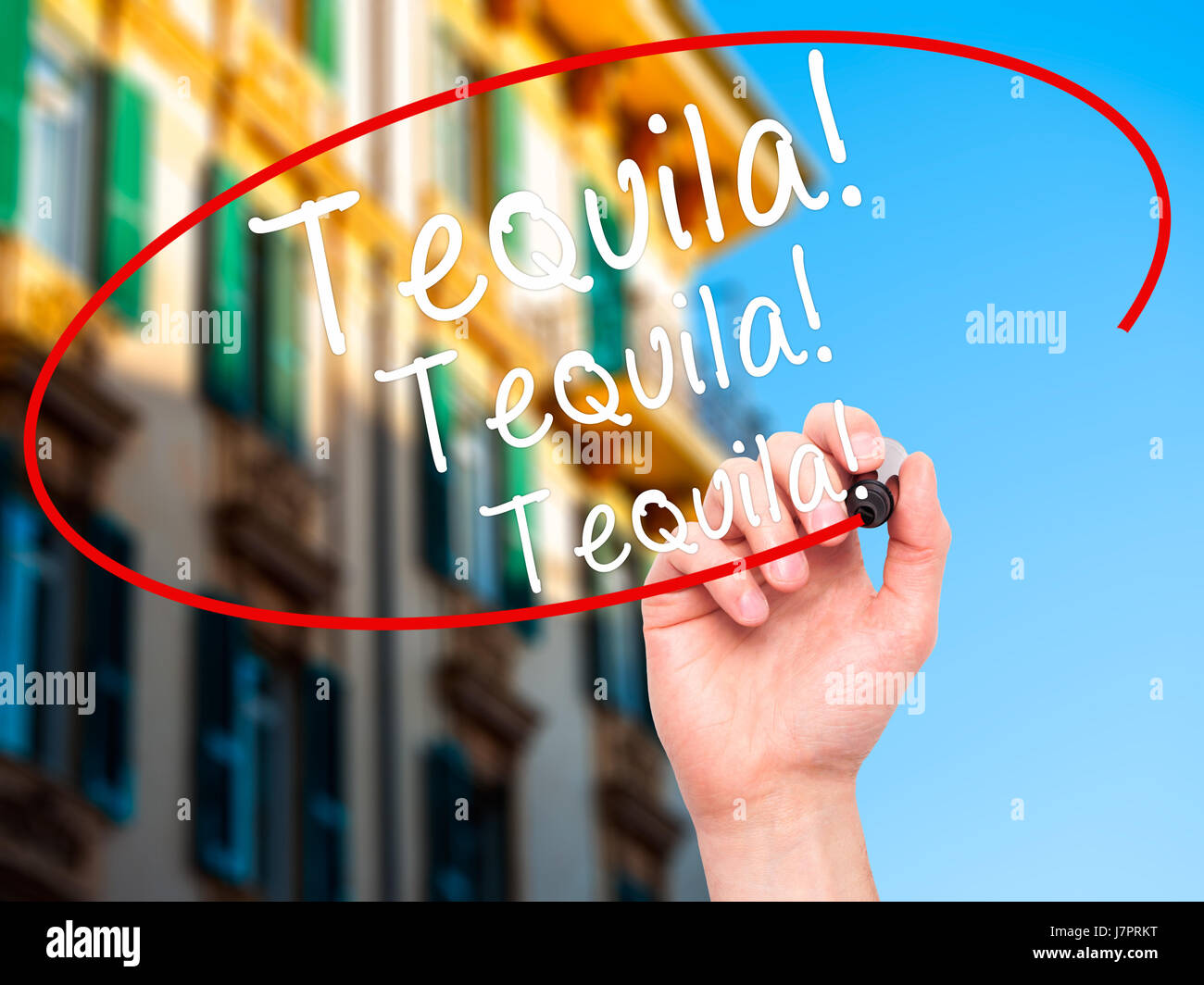 Man Hand writing Tequila with black marker on visual screen. Isolated on city. Business, technology, internet concept. Stock Photo Stock Photo