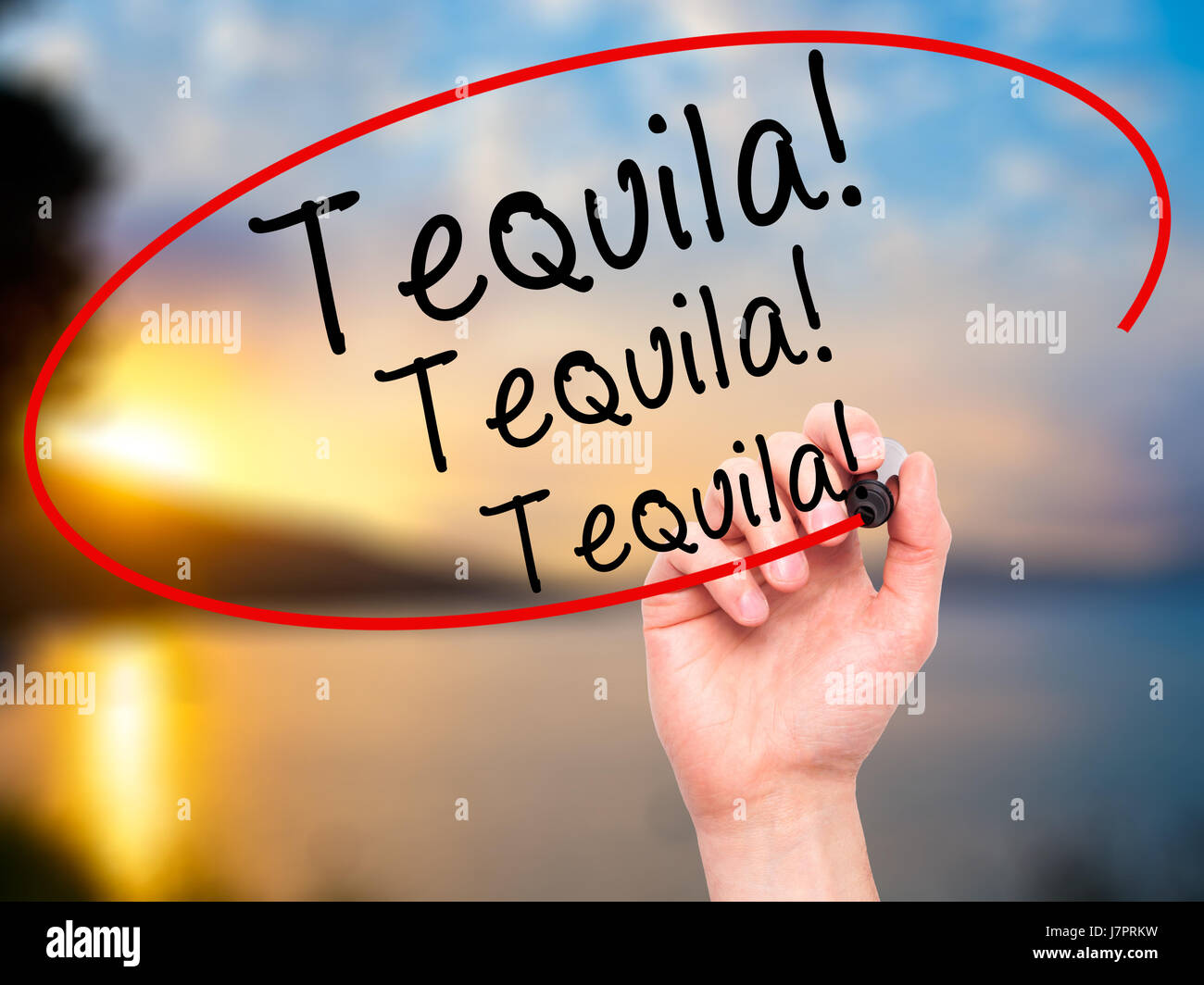 Man Hand writing Tequila with black marker on visual screen. Isolated on nature. Business, technology, internet concept. Stock Photo Stock Photo