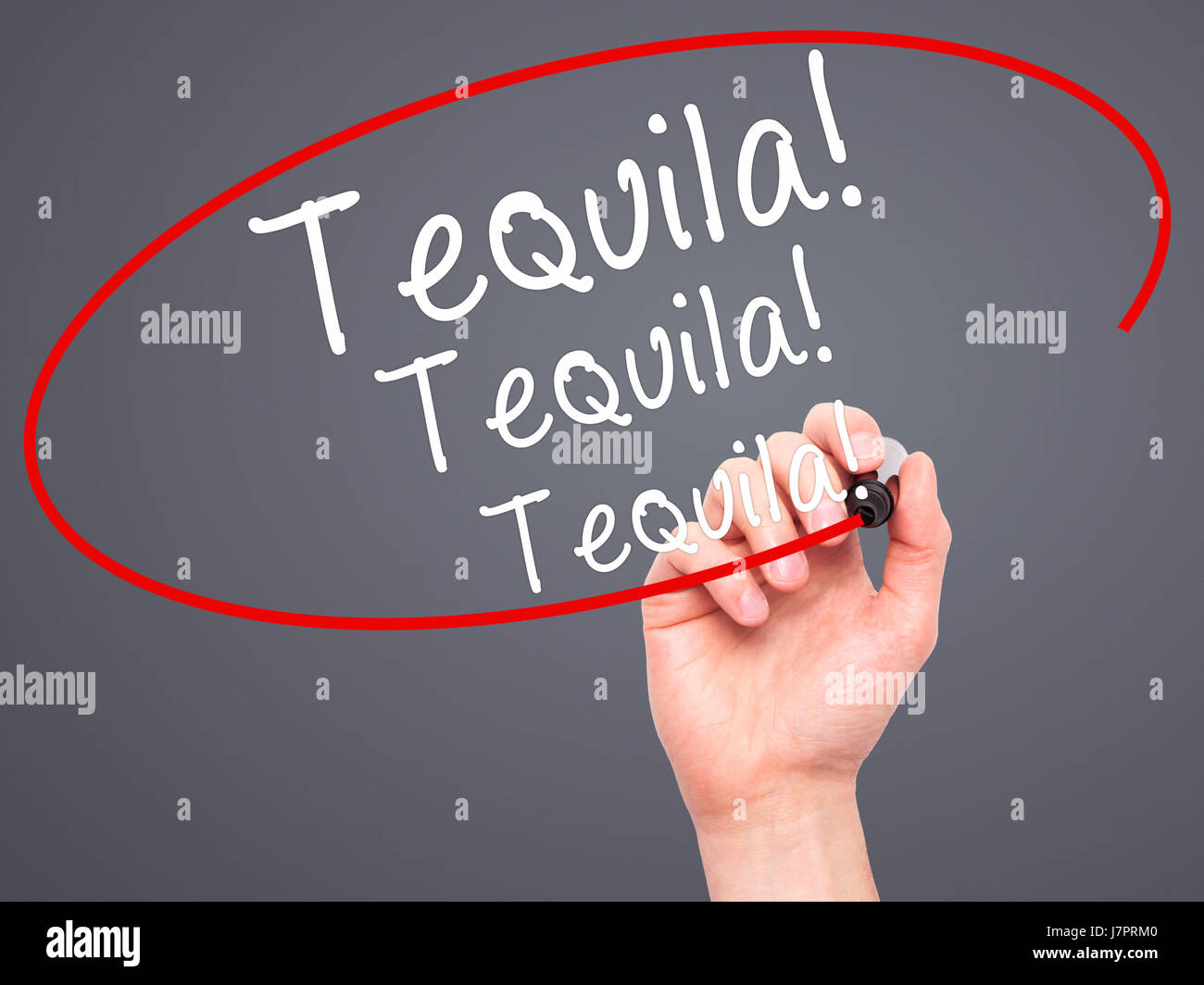 Man Hand writing Tequila with black marker on visual screen. Isolated on grey. Business, technology, internet concept. Stock Photo Stock Photo