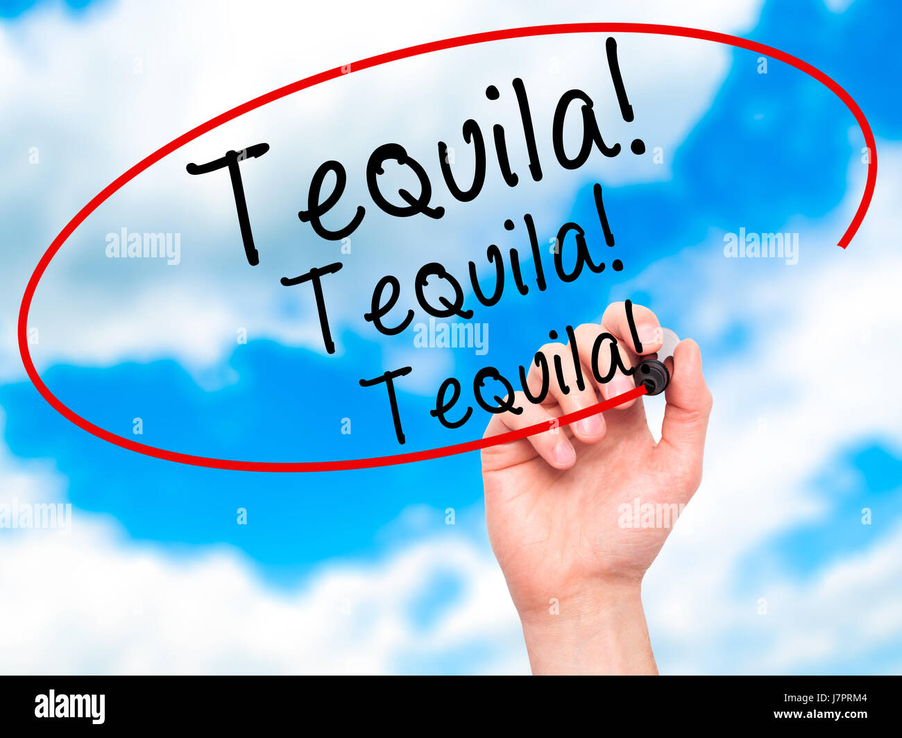 Man Hand writing Tequila with black marker on visual screen. Isolated on sky. Business, technology, internet concept. Stock Photo Stock Photo