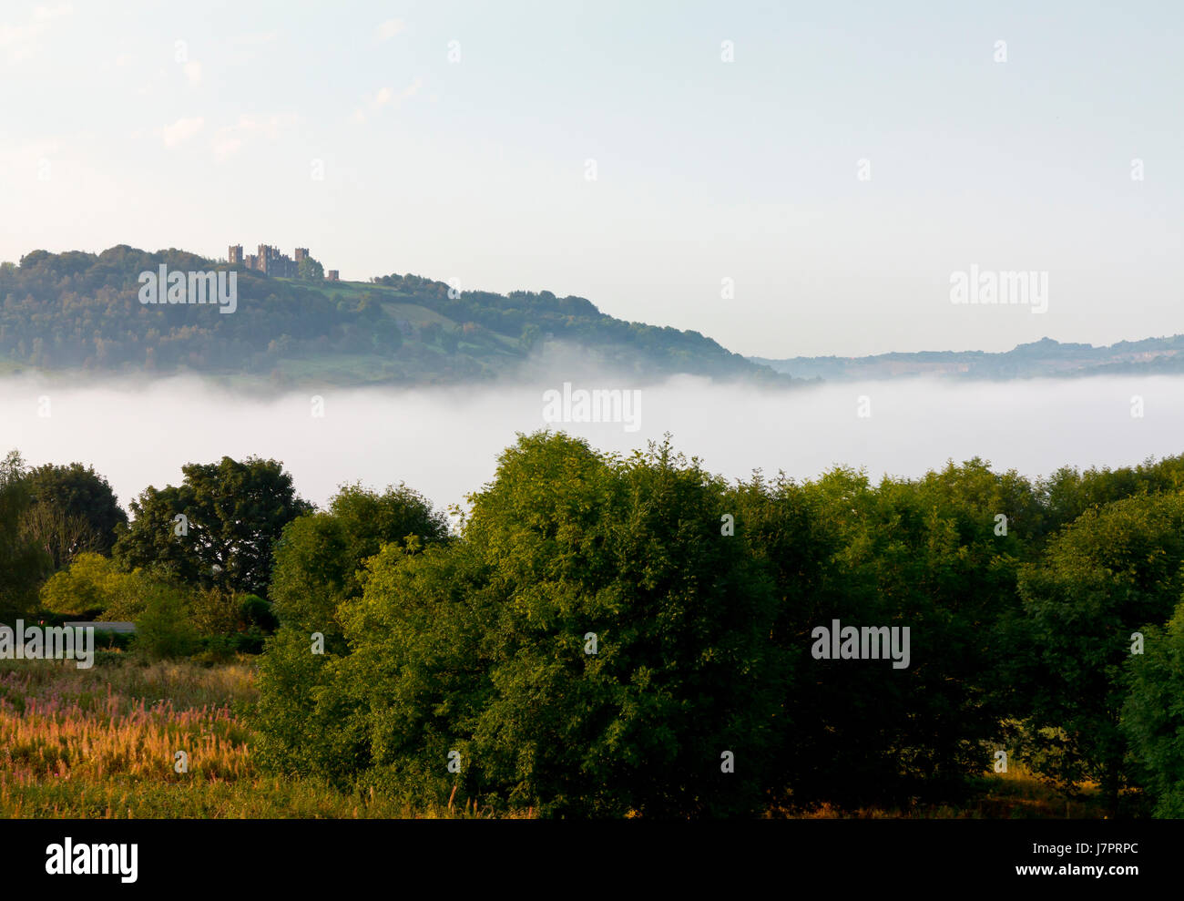 Temperature inversion with mist in the valley and clear skies above Matlock Derbyshire Peak District England UK with Riber Castle on the hill beyond Stock Photo