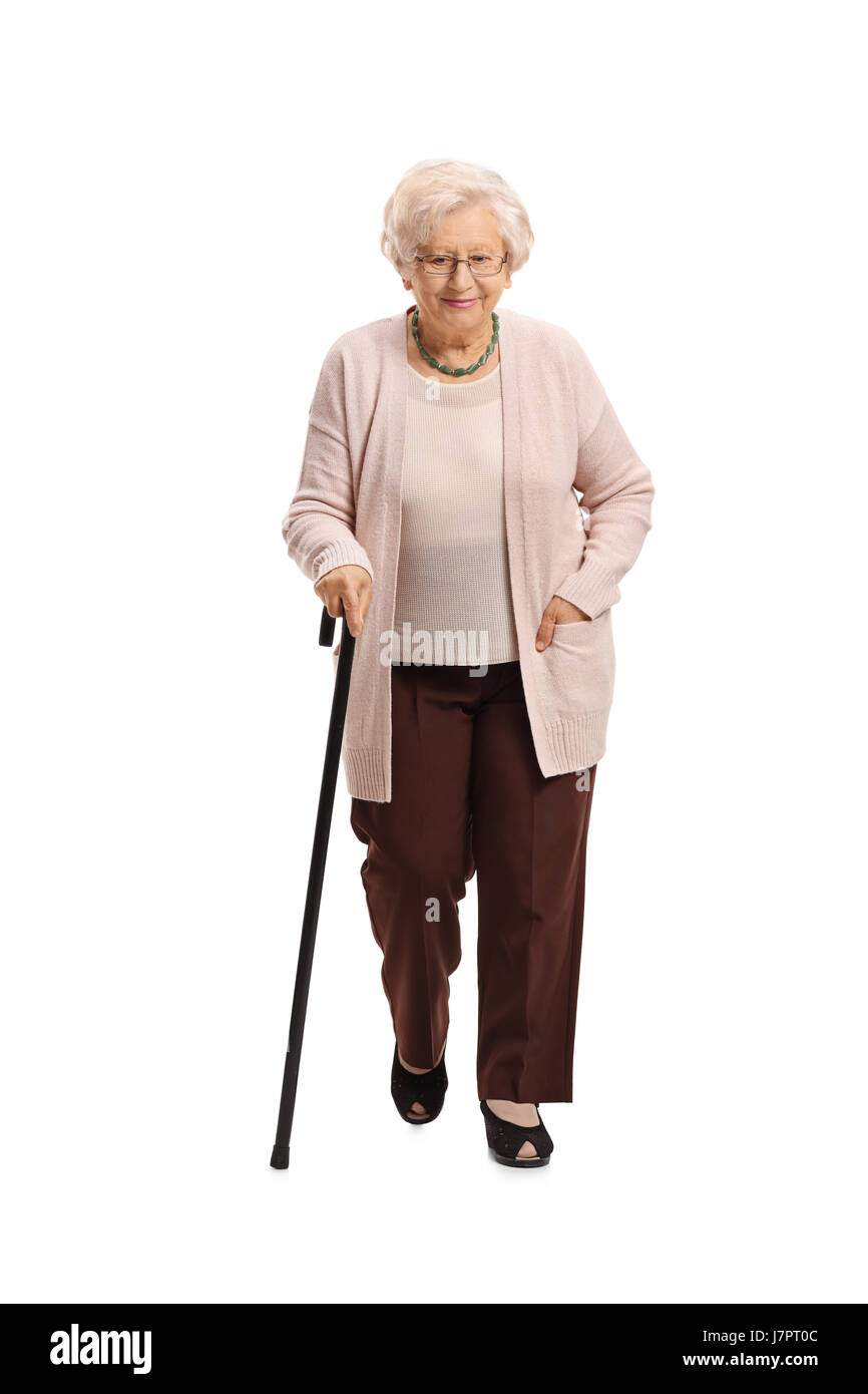 Full length portrait of a mature woman with a cane walking towards the camera isolated on white background Stock Photo